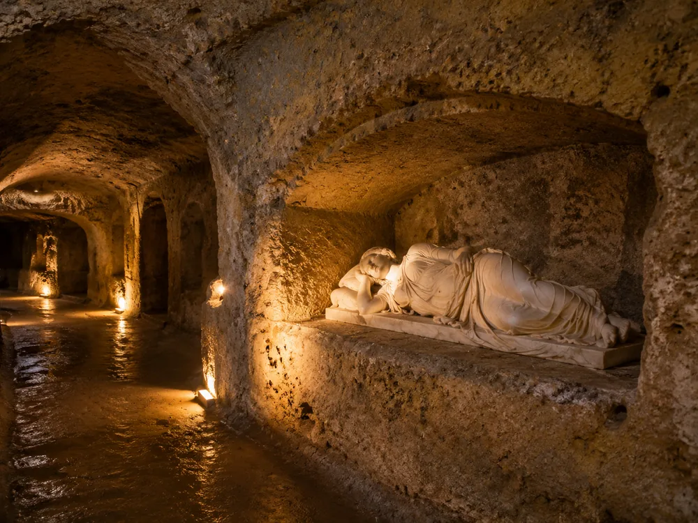 A reclining figure in a niche; the statue in St Cecilia&rsquo;s crypt is a copy of Maderno&rsquo;s